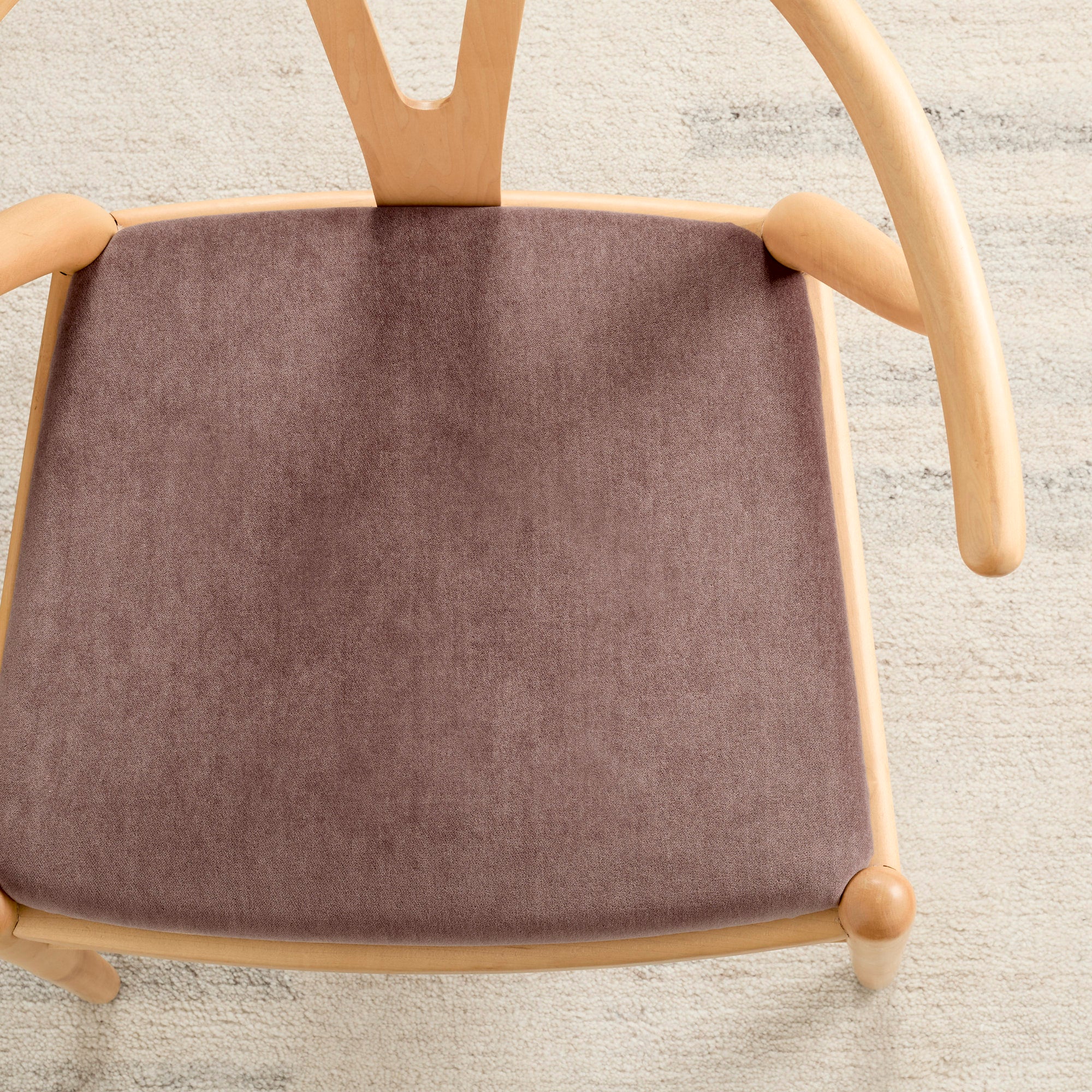 Tonic Living Florence Velvet Mauve upholstery fabric shown on a dining chair in muted purple velvet