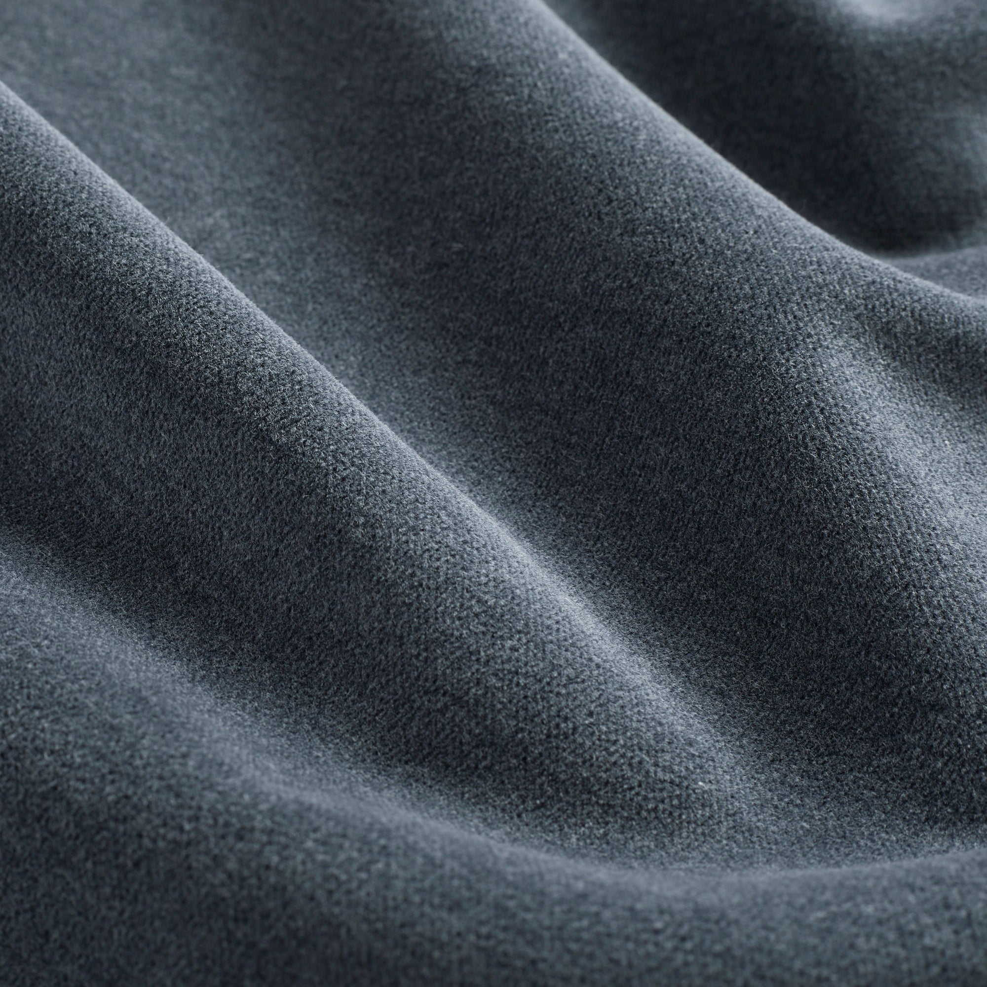 Close up of Tonic Living Florence Velvet upholstery fabric showing its smooth, plush texture in Mineral Blue.