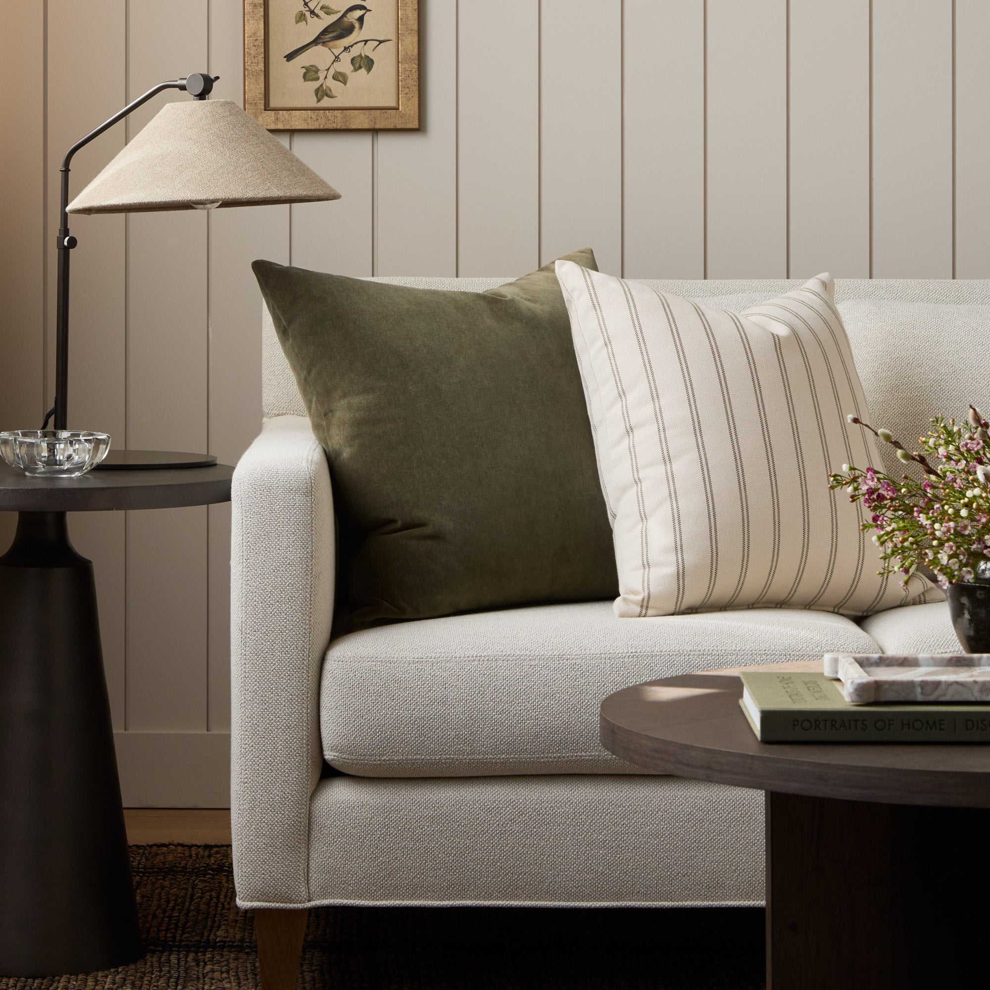 Tonic Living Florence Velvet Olive green throw pillow styled on a sofa with the Rexton Stripe Moss green cushion.