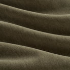 Close up of Tonic Living Florence Velvet Olive upholstery fabric showing its plush green velvet texture.