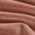 Close up of Tonic Living Florence Velvet Rosewood upholstery fabric showing its plush dusty rose texture.