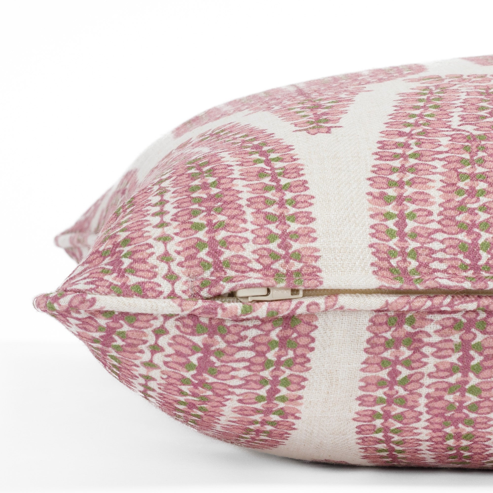 Close-up zipper view of a pink, leafy green and natural pillow with piped detail and botanical pattern (Georgia Orchid Pink 20x20 pillow from Tonic Living).