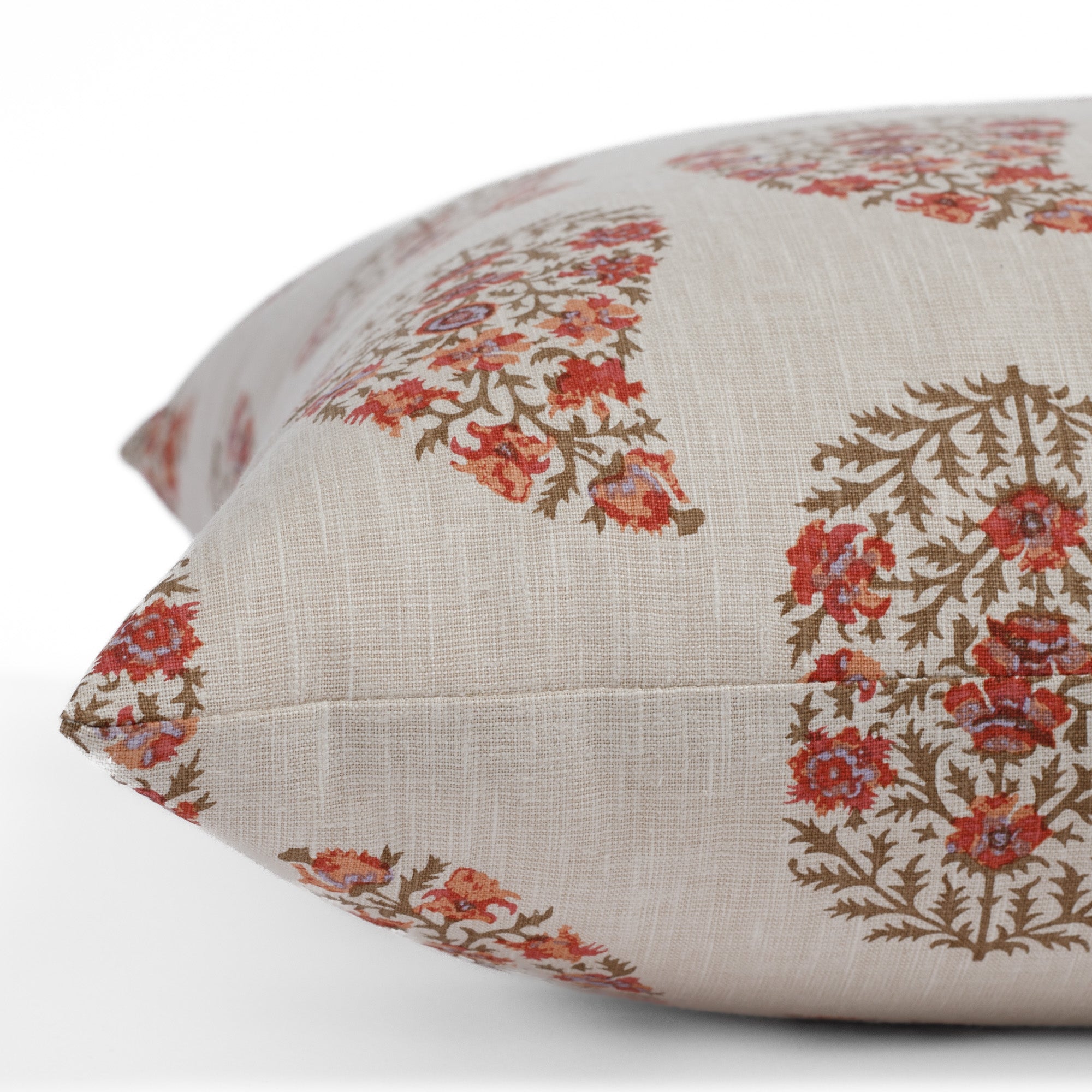 Side angle view of Tonic Living Grace 20x20 Pillow, Rosewood with multicolour paisley floral print.