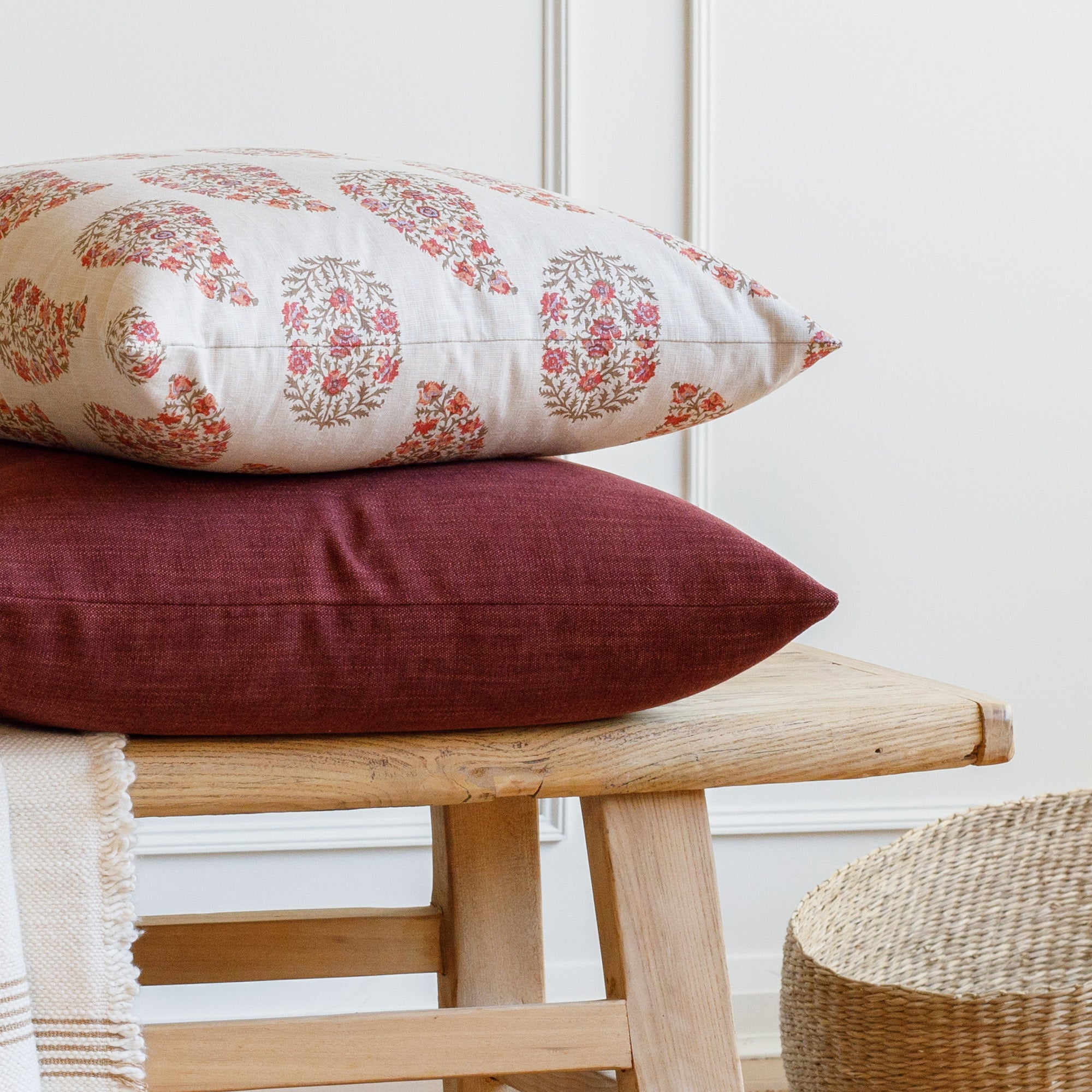 Stacked Tonic Living pillows: Grace 20x20 Pillow, Rosewood with Bedford 22x22 Pillow, Merlot.