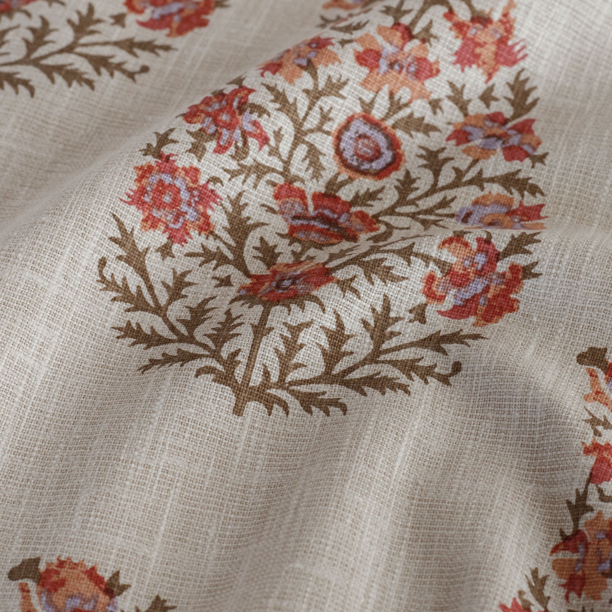 Close-up of Tonic Living Grace Rosewood paisley floral fabric with vintage block print.