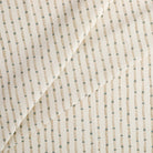 Tonic Living Hadley Stripe Fabric, a striped drapery fabric in off-white, light brown, and blue with a classic decorative design.