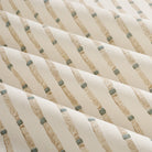 Close up of Tonic Living Hadley Stripe Fabric shown rippled, highlighting its blue and brown bamboo-inspired stripe pattern.