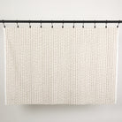 Full yard of Tonic Living Hadley Stripe Fabric hanging to show the scale and drape of its blue and brown striped pattern.