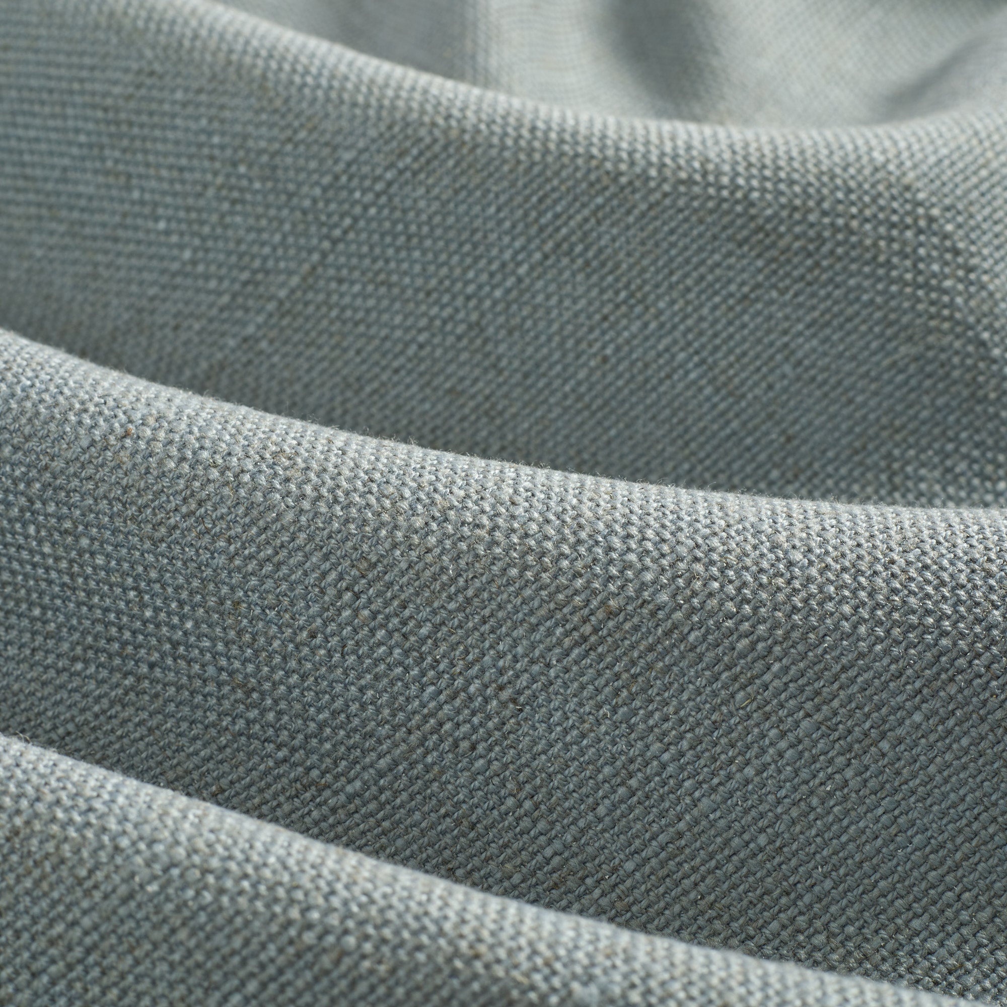 Close up of Tonic Living Hampton Chambray fabric showing textured blue weave with a linen-inspired finish.