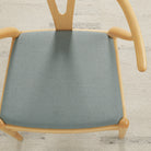 Tonic Living Hampton Chambray high-performance upholstery fabric on a dining chair seat in soft blue linen-look texture.
