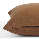Side zipper detail of Tonic Living Hampton 22x22 pillow in warm cinnamon brown with a linen-inspired texture.