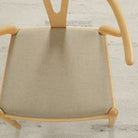 Tonic Living Hampton Flax high-performance upholstery fabric on a dining chair seat in soft beige linen-look texture.