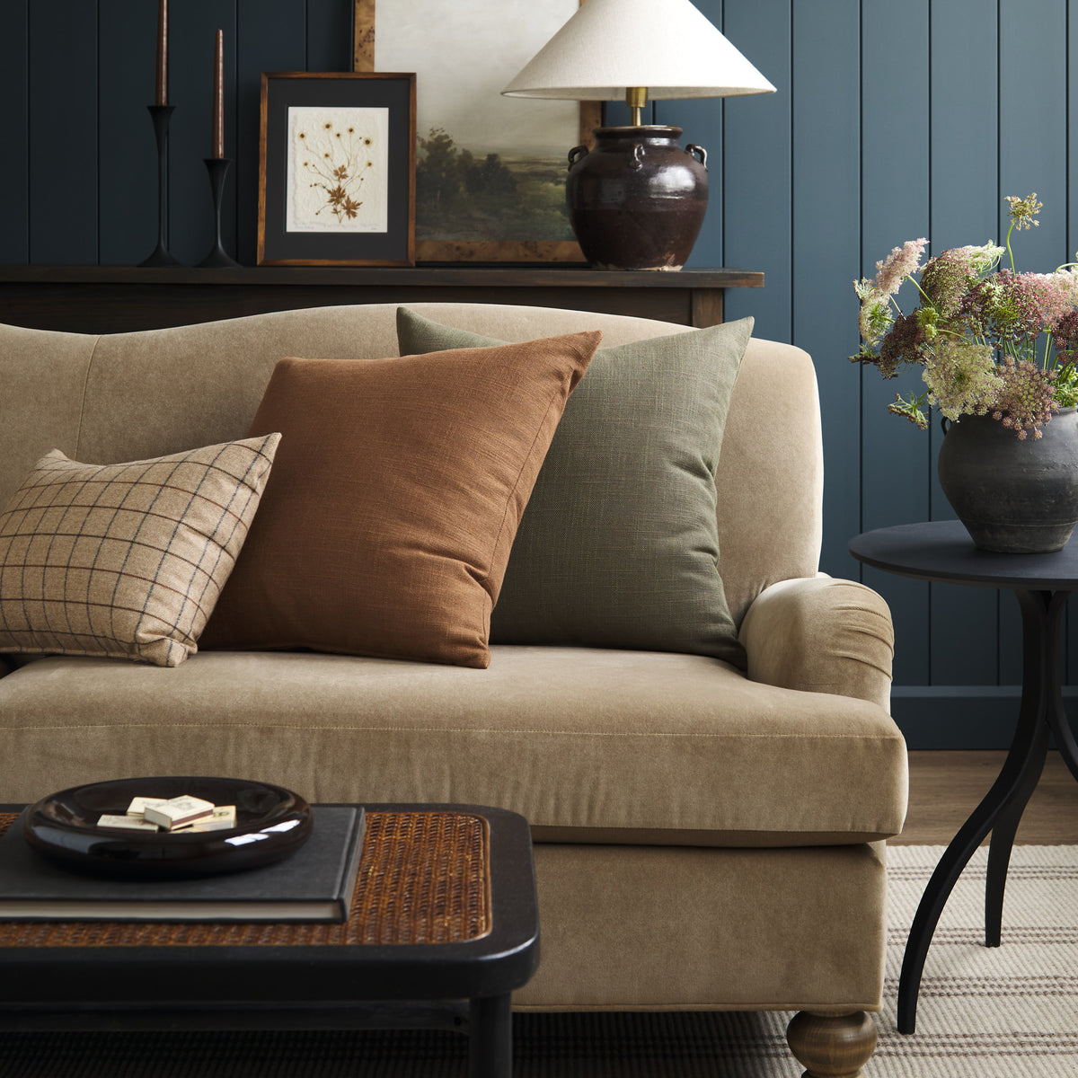 Tonic Living Hampton Cinnamon throw pillow styled on a sofa with a mix of earthy Tonic Living pillows in a moody living room.