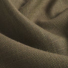Close up of Tonic Living Hampton Moss upholstery fabric showing its earthy green colour, moss tones, and linen-like woven texture.