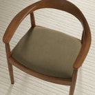 Tonic Living Hampton Moss high-performance upholstery fabric shown on a dining chair seat in a rich moss green.