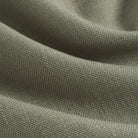 Close up of Tonic Living Hampton Sage fabric showing textured green weave with a linen-inspired finish.