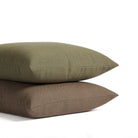 Stack of Tonic Living Hampton pillows in Walnut dark brown and Moss earthy green with linen-inspired texture.