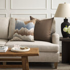 Tonic Living Hampton Walnut brown throw pillow styled on a sofa with Cortina Storm blue and brown abstract pillow.