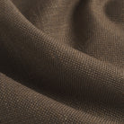 Close up of Tonic Living Hampton Walnut upholstery fabric showing its dark brown colour, smoky walnut tones, and linen-like woven texture.