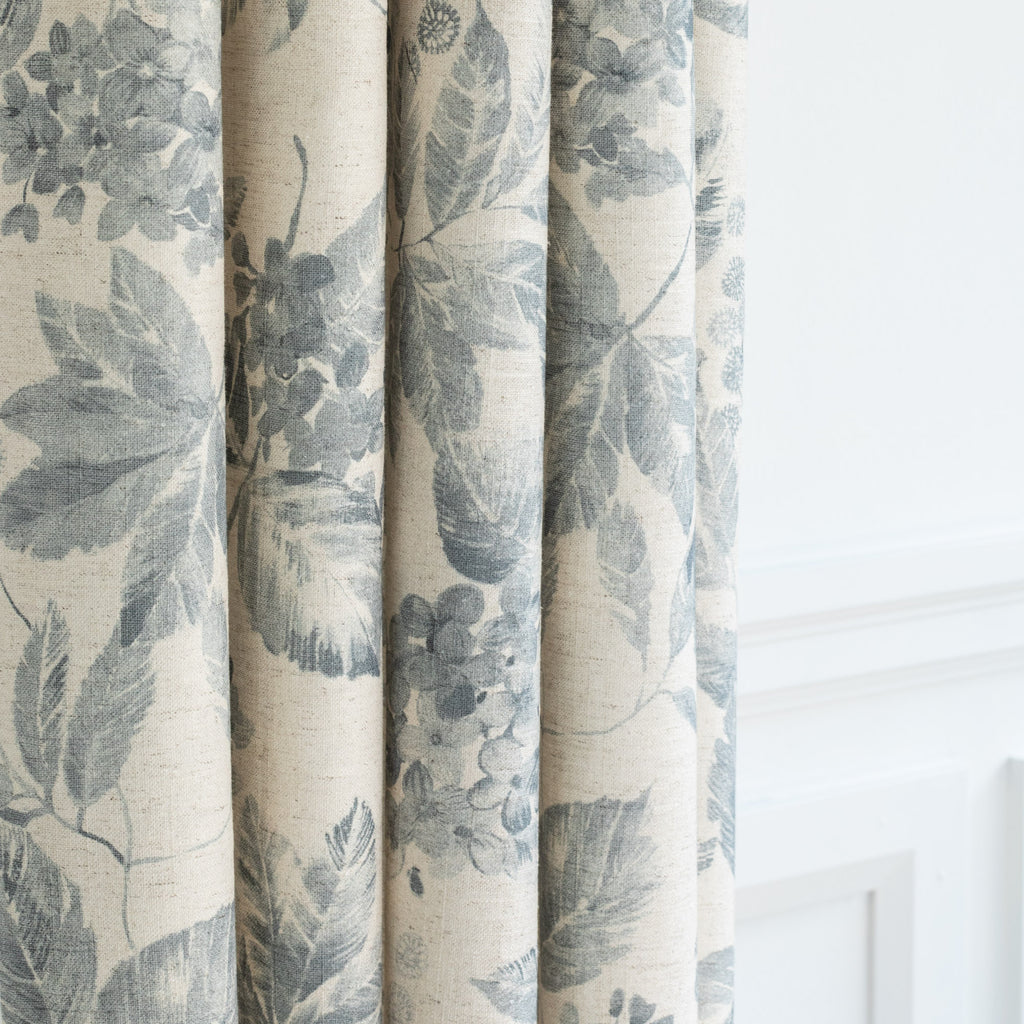 an oatmeal cream and blue botanical floral pattern curtain fabric