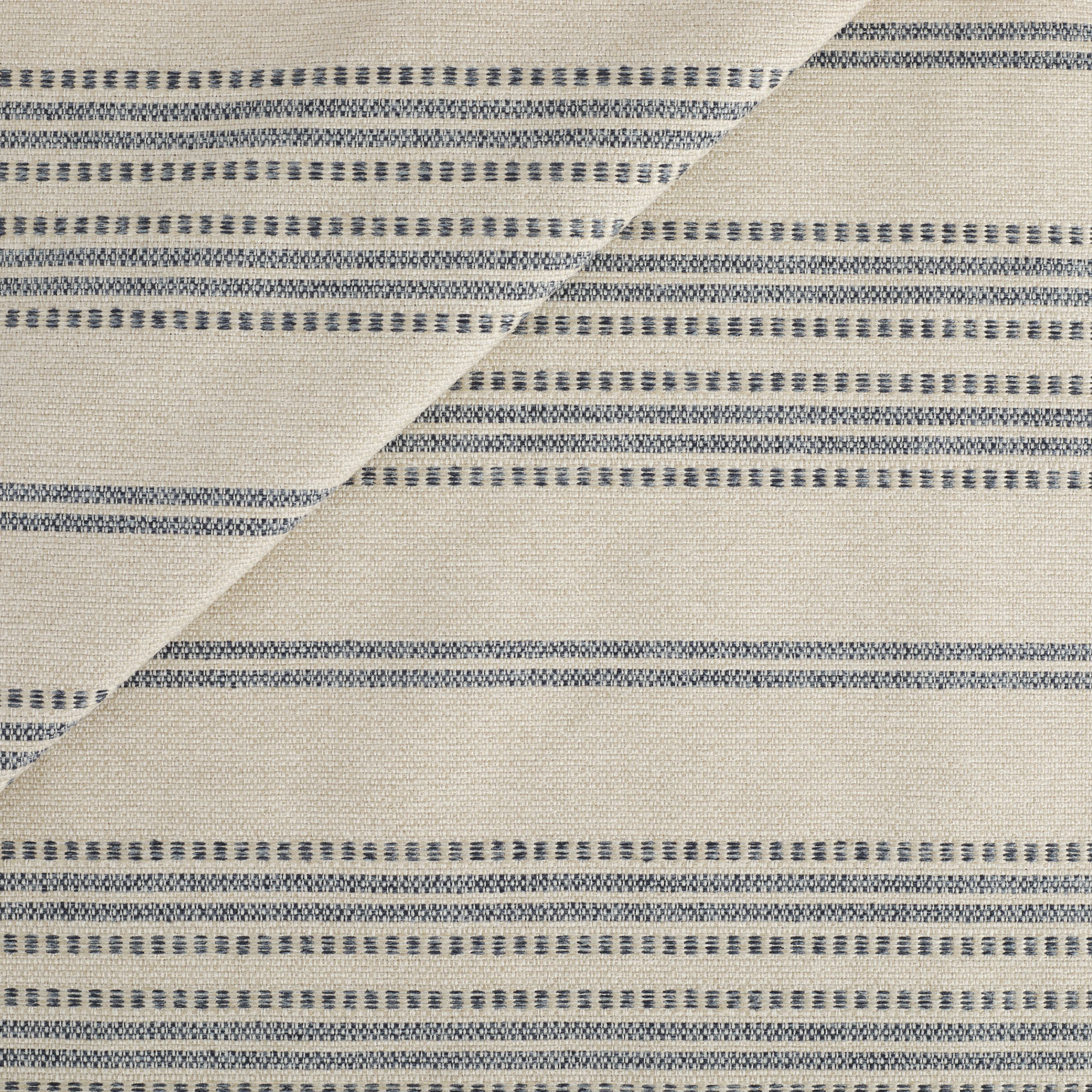 Tonic Living Hopper Stripe Fabric in Denim, a high-performance upholstery fabric with denim blue stripes on a light tan background.