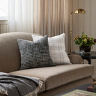 Tonic Living Hugo Plaid cushion paired with Otto Domino 20x20 pillow styled on a sofa.