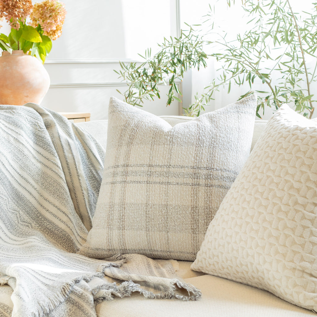 Neutral palette throw pillow and blanket from Tonic Living