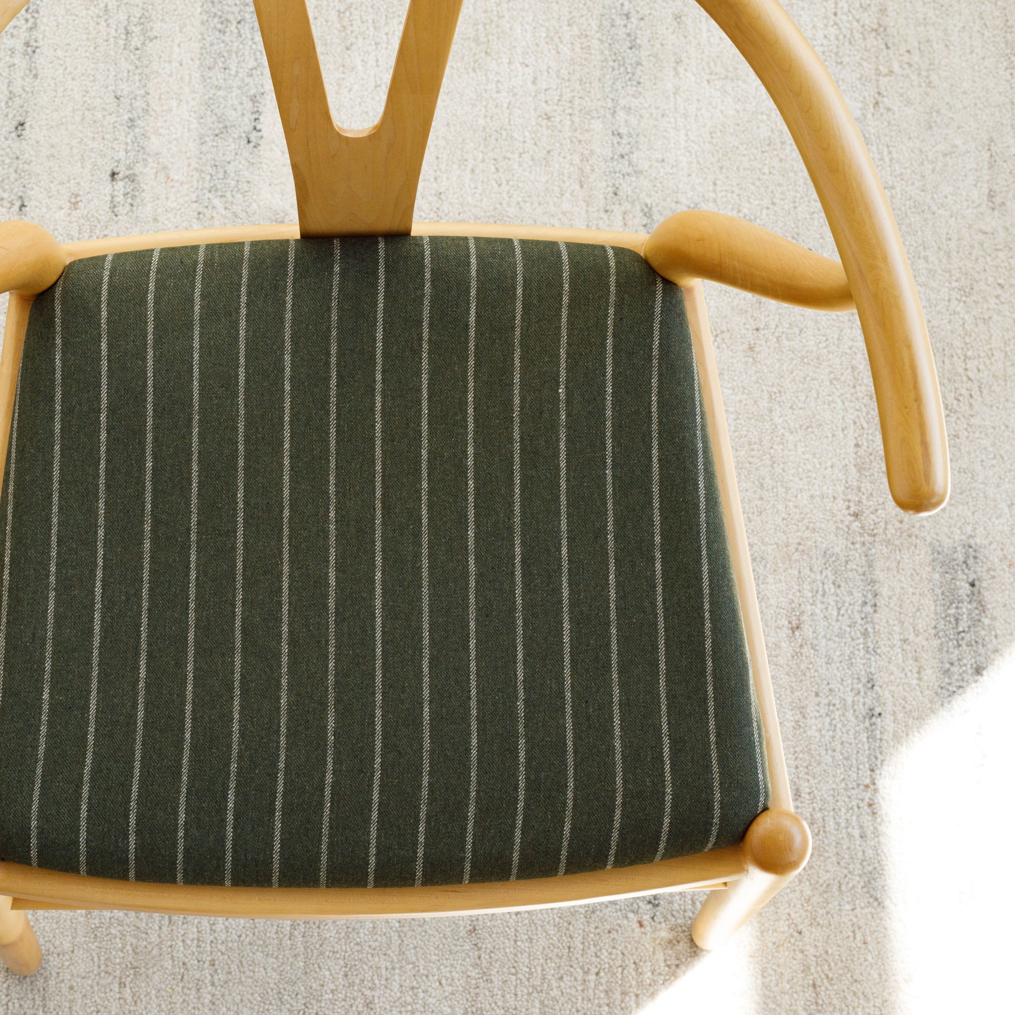 a moss green and  cream pinstripe upholstered chair seat