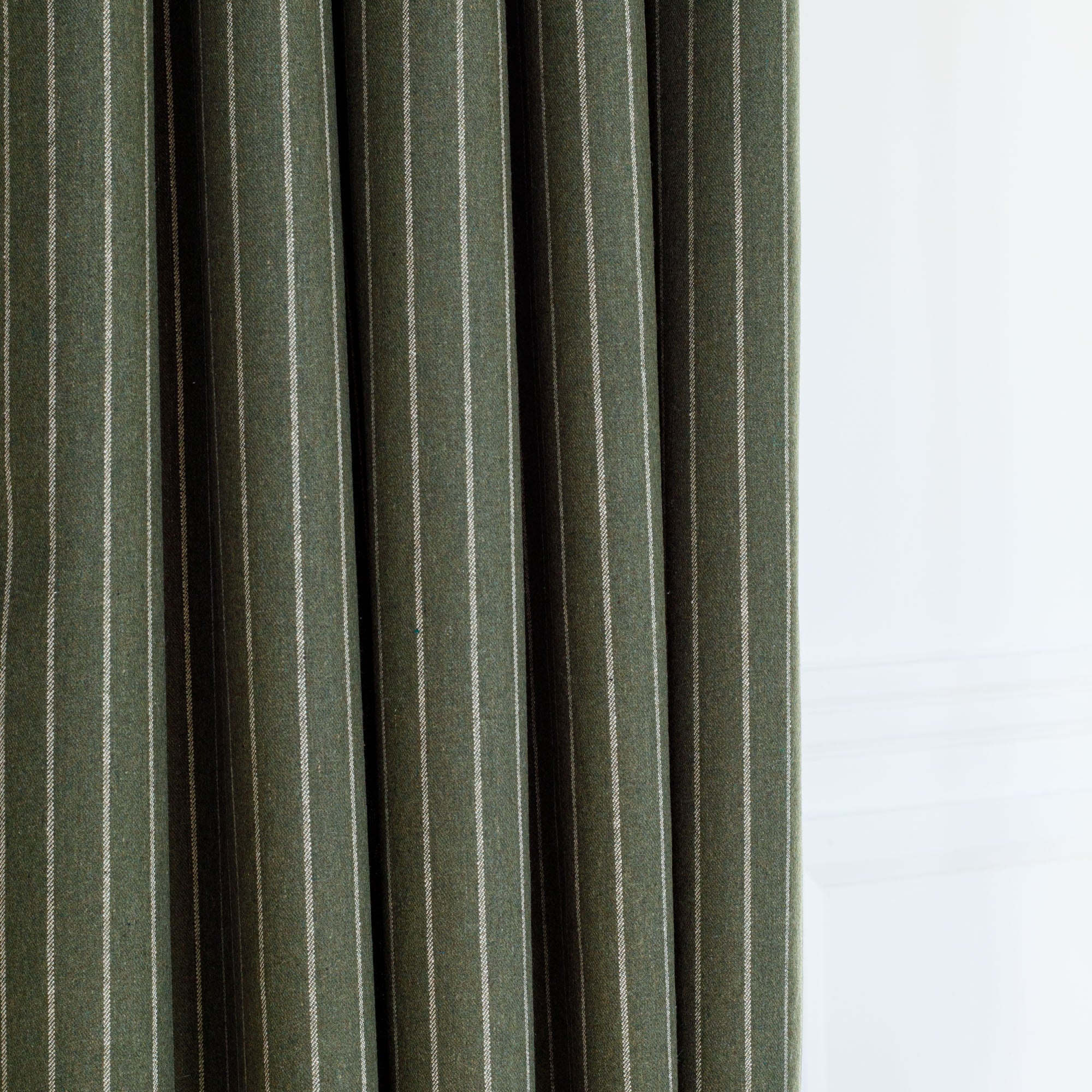 a moss green and cream vertical pinstripe drapery fabric from Tonic Living