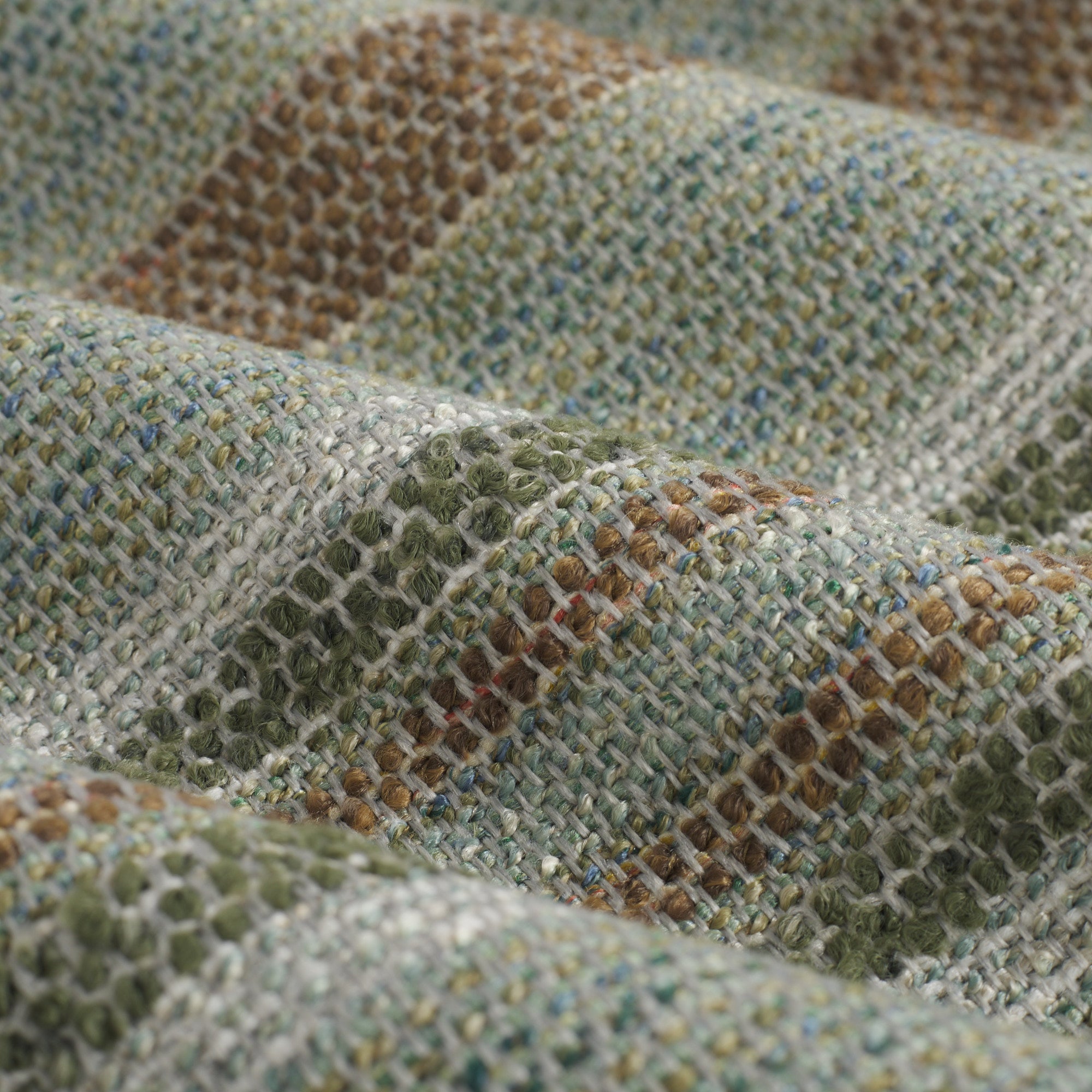 Close up of Tonic Living Indie Lagoon upholstery fabric highlighting raised nubby stripes in green-teal tones.