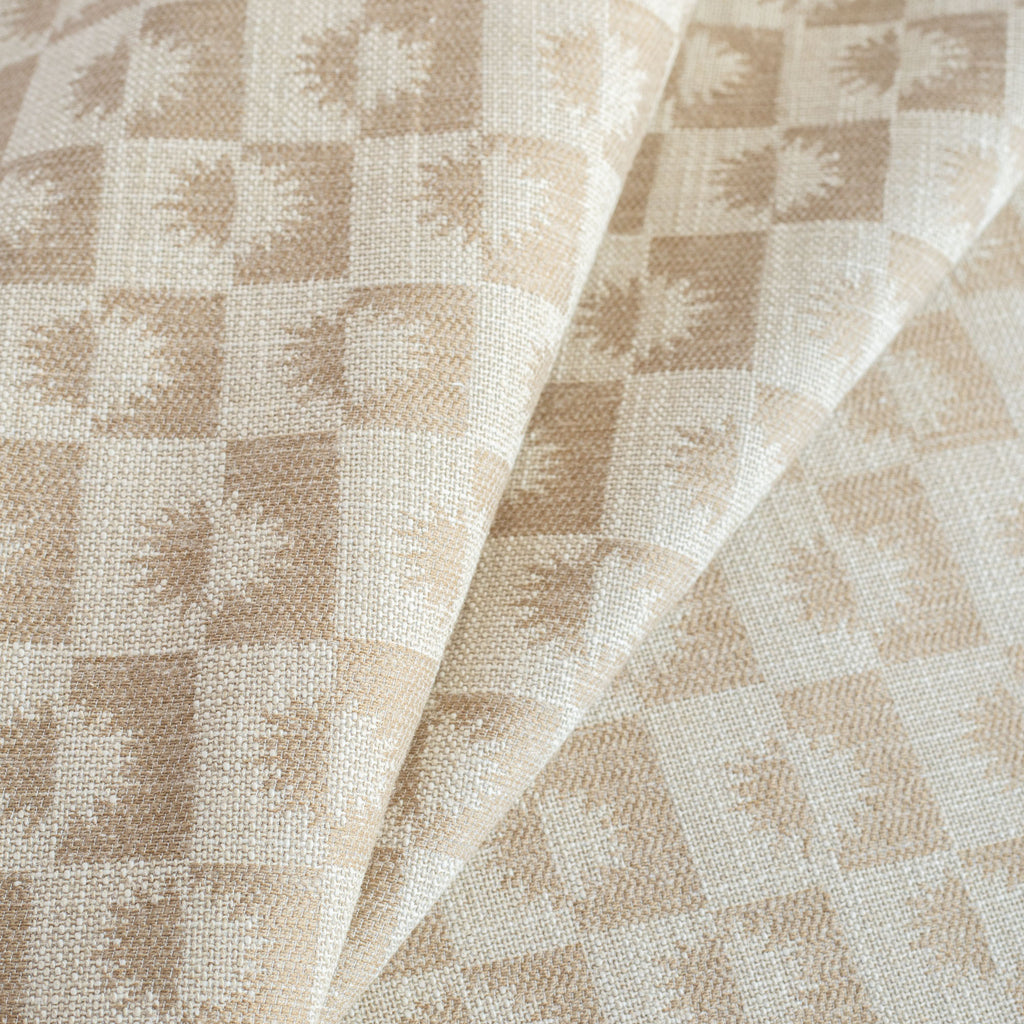 a cream and beige brown checkboard, sun motif patterned upholstery : close up view 2