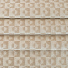 a cream and beige brown checkboard, sun motif patterned upholstery Tonic Living fabric
