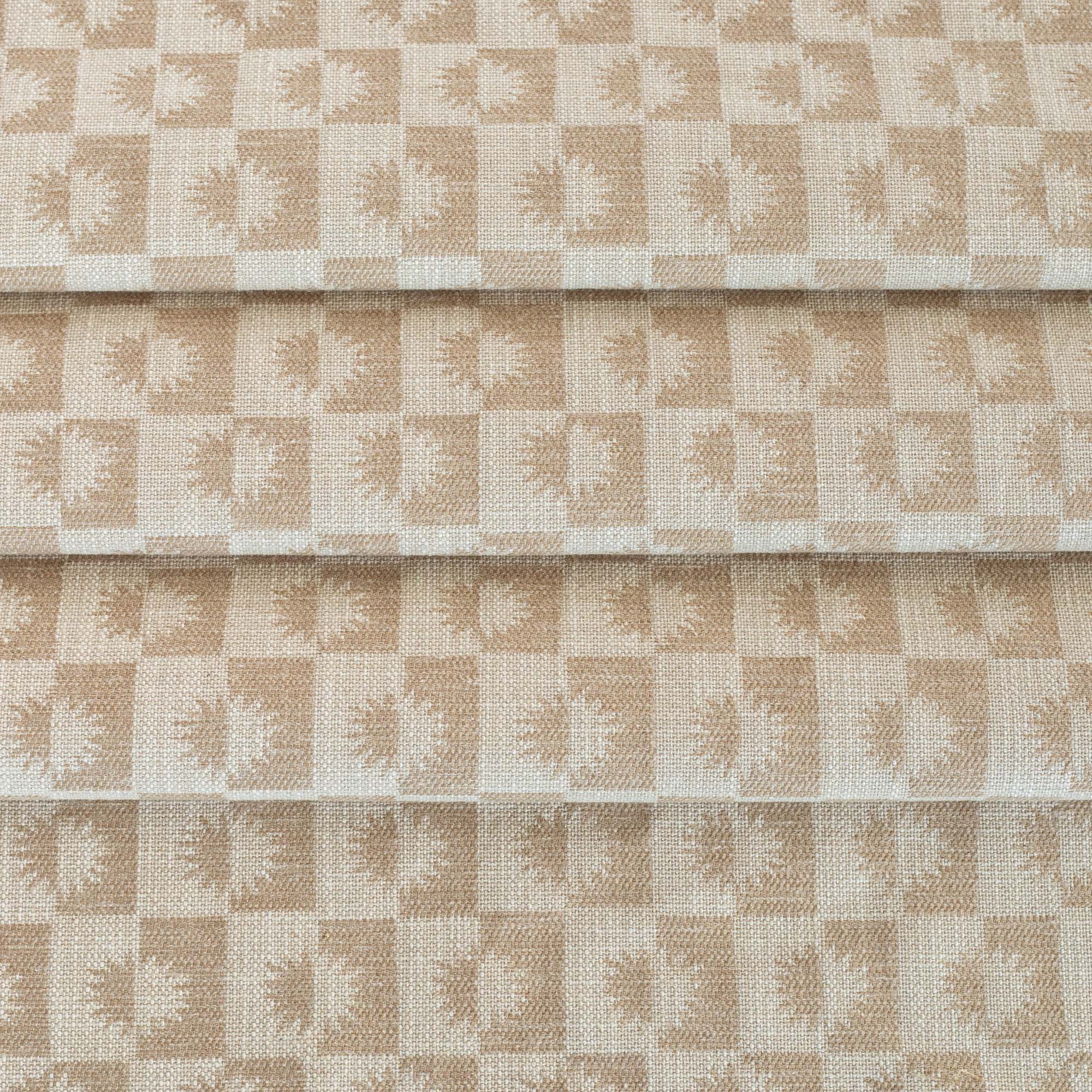 a cream and beige brown checkboard, sun motif patterned upholstery Tonic Living fabric