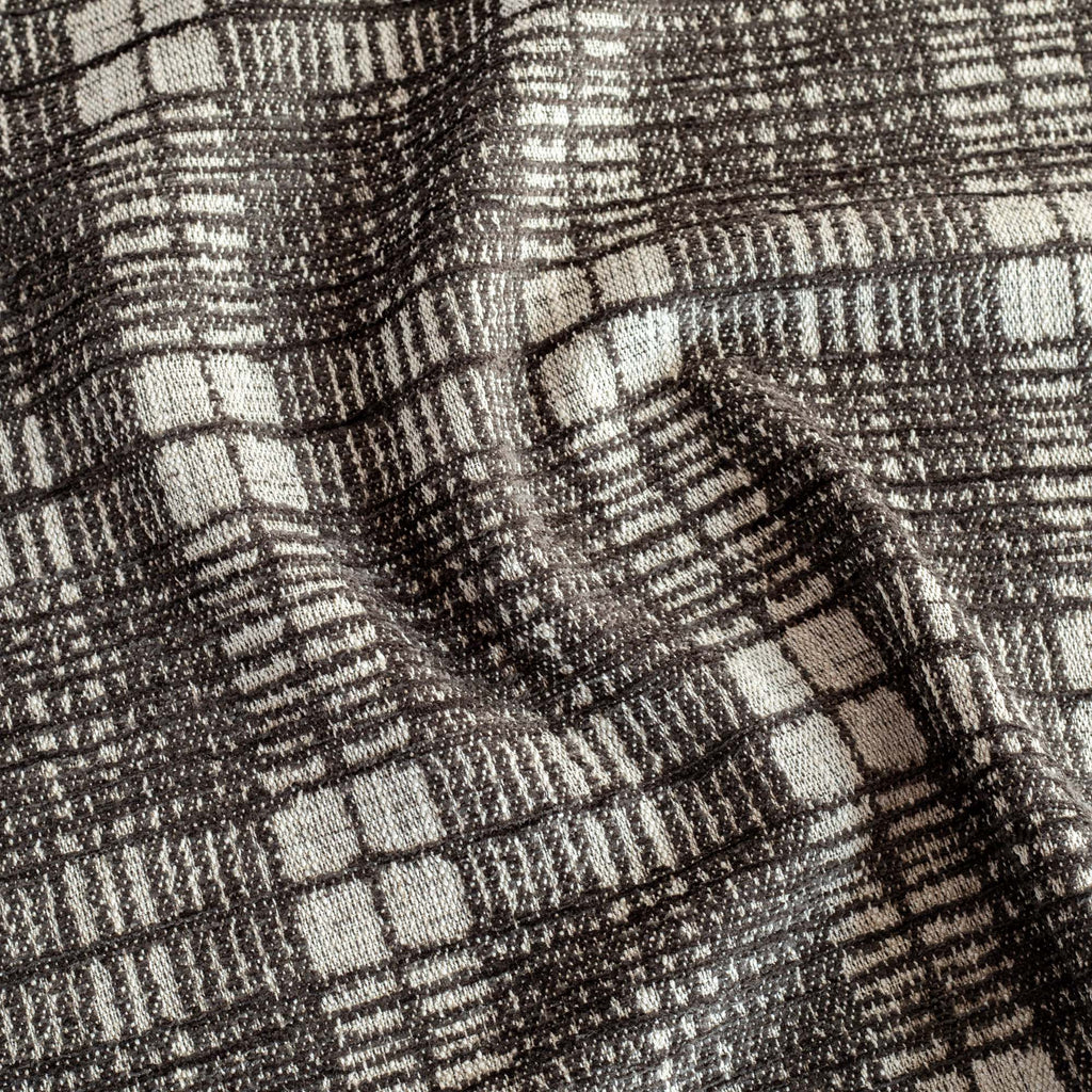 a black and natural coloured plaid upholstery fabric