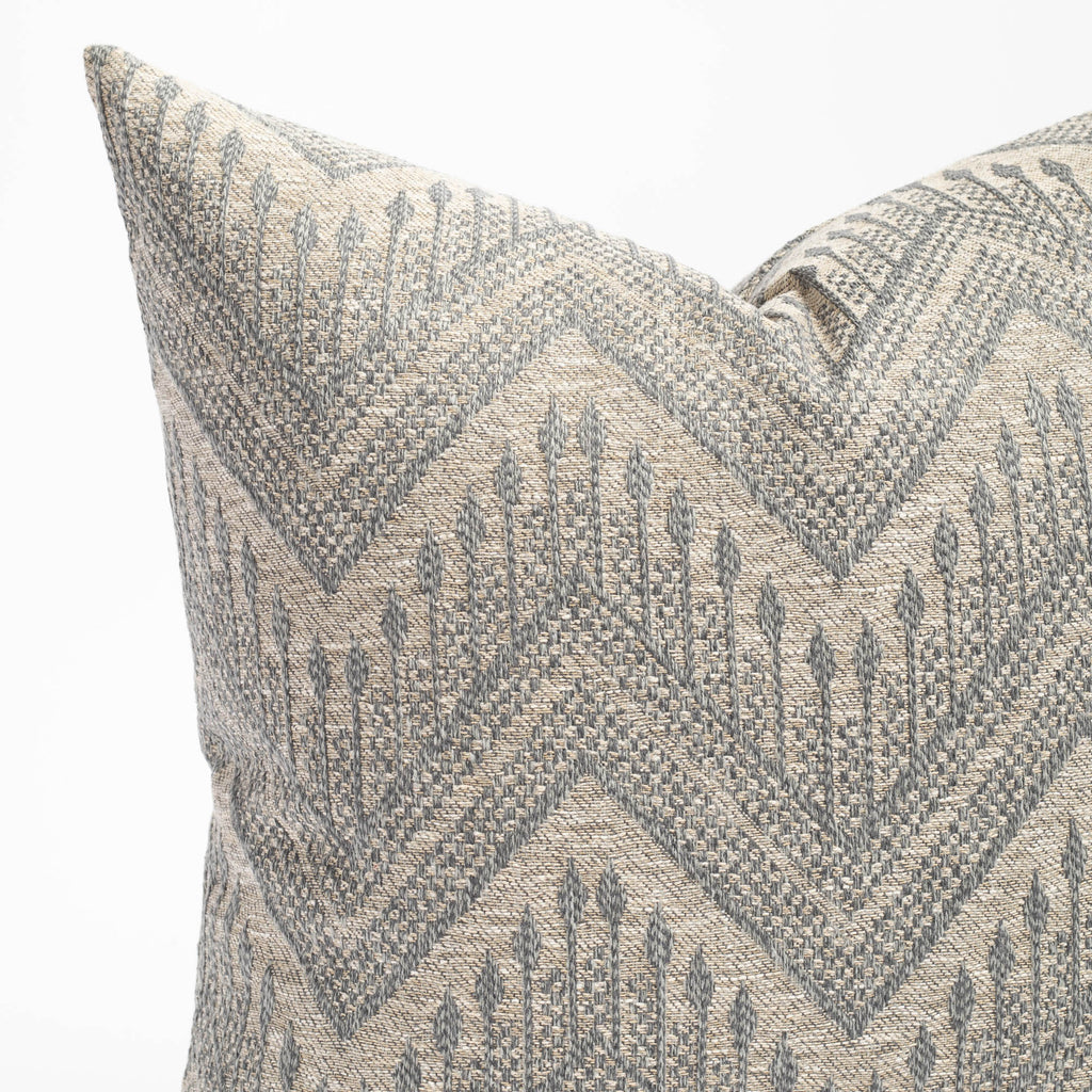 a grey and denim blue intricate zig zag patterned throw pillow : close up view