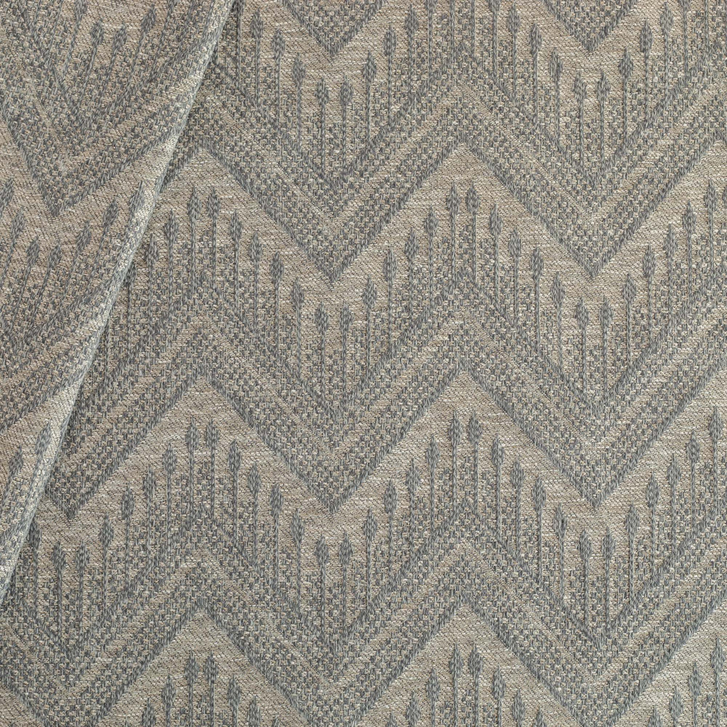 Joyce Fabric denim, a warm grey upholstery fabric with a delicate woven blue geometric zig zag pattern from Tonic Living