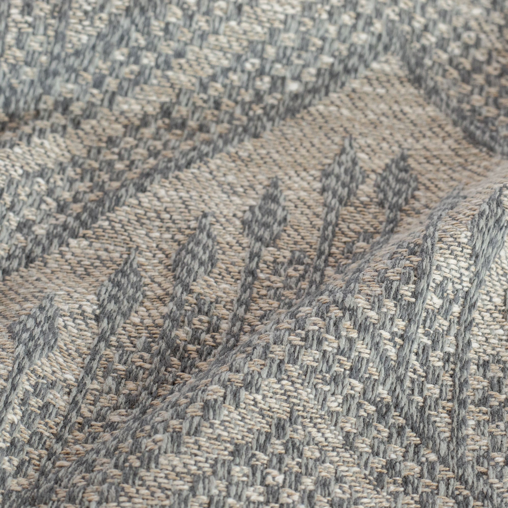 a warm grey and stone blue tapestry woven upholstery fabric :close up view