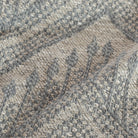 a warm grey and stone blue tapestry woven upholstery fabric :close up view