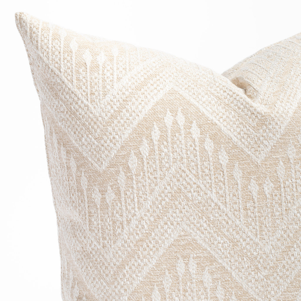 an oatmeal beige and white intricate zigzag patterned throw pillow : close up view