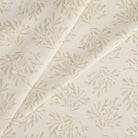 Tonic Living Juniper Fabric in Parchment featuring a subtle sprig pattern in warm neutral cream tones.
