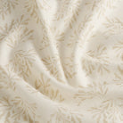 Tonic Living Juniper Parchment home decor fabric with a delicate botanical print in beige and soft white tones.