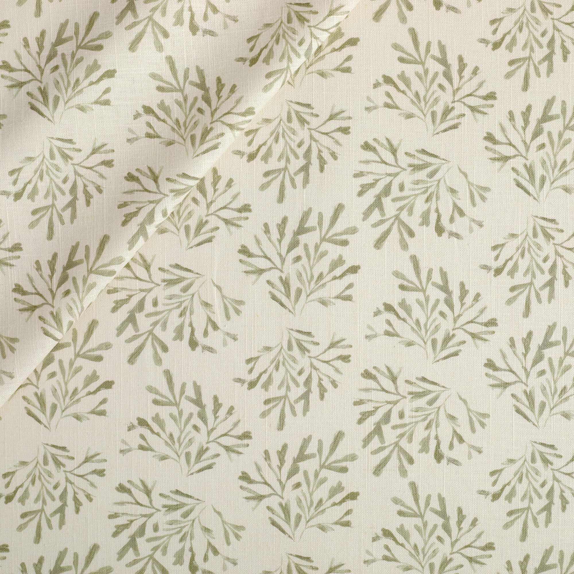 Tonic Living Juniper Fabric in Sage, a faded sage green and cream botanical print drapery fabric with sprig pattern.