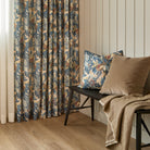 Juno 20x20 Pillow, Navy by Tonic Living styled on a bench with Valentina Velvet Pillow, Toffee, in front of matching Juno Navy floral drapery fabric.