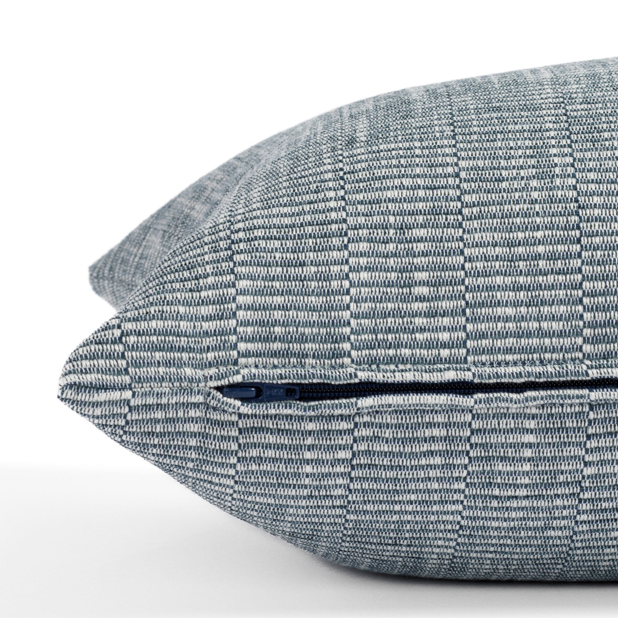 a blue and white textured stripe extra long lumbar throw pillow : close up zipper detail