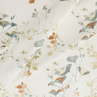 Tonic Living Laurel Meadow home decor fabric with a delicate botanical pattern in earthy blue and terracotta tones.