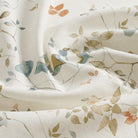 Tonic Living Laurel Fabric in Meadow featuring leafy vine florals in a muted multicolour palette.