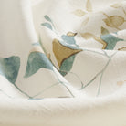 Close up of Tonic Living Laurel Meadow fabric showing its linen-blend texture and floral vine detail.
