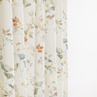 Tonic Living Laurel Meadow curtain fabric in a soft blue, terracotta, and white botanical design.