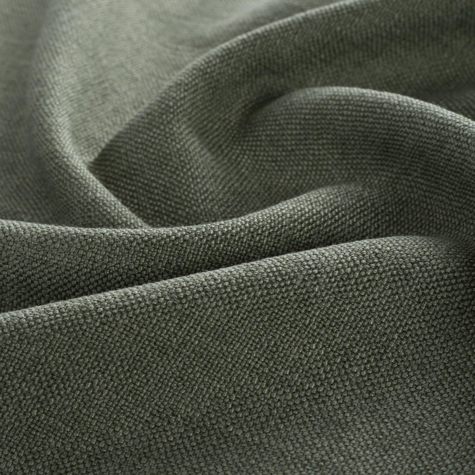 Close-up of Loden Fabric, Sage by Tonic Living — high-performance upholstery fabric in a dusty sage green tone with linen-like texture.