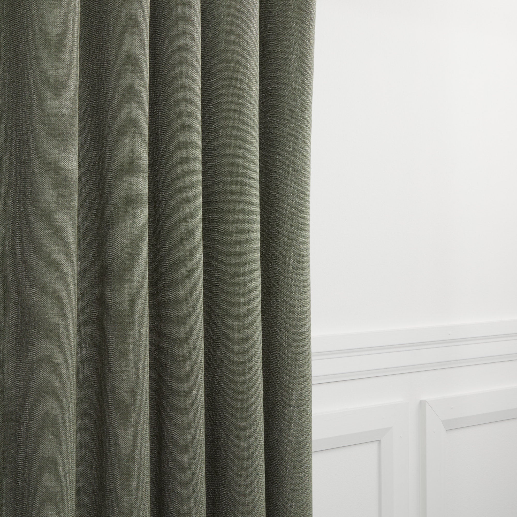 Loden Fabric, Sage by Tonic Living — high-performance linen-look fabric in muted sage green, shown as drapery.